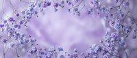 Delicate purple flowers create romantic heart-shaped frame on soft lavender background for wedding invitations, Valentine's Day cards and love-themed designs.