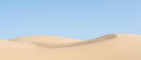 Smooth sand dunes with flowing curves against clear blue sky, suitable for travel, nature, and desert landscape backgrounds.