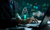 Businessman launching digital rocket startup concept with glowing holographic icons above laptop keyboard representing innovation and business growth.