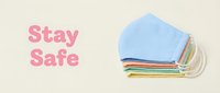 Stack of colorful reusable fabric face masks in pastel shades with Stay Safe text on beige background, health protection concept.