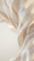 Luxurious cream silk fabric with delicate water droplets creating elegant flowing texture for premium fashion and textile design projects.