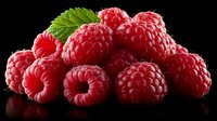 Fresh ripe raspberries with green leaf isolated on black background, healthy organic berries for dessert or natural ingredient in cooking.