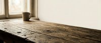Rustic wooden windowsill with ceramic mug in natural daylight, suitable for home decor, lifestyle, and interior design projects.
