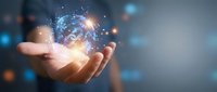 Businessman holding glowing digital brain with neural network connections and data particles floating above open palm in futuristic technology concept.