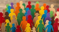 Colorful wooden human figures representing diversity, teamwork and community standing together on wooden surface for business concepts.