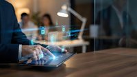 Business professional using secure digital tablet with cybersecurity icons and data protection symbols in modern office environment for technology solutions.