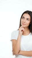 Young woman in white t-shirt looking up thoughtfully with hand on chin, contemplating ideas on isolated white background for creative projects.