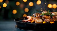 Grilled seafood platter with juicy scallops and prawns in cast iron pan against warm bokeh lights, creating festive dining atmosphere.