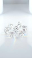 Clear crystal polyhedral dice set with rainbow reflections on white studio background for tabletop gaming and role-playing adventures.