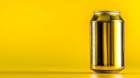 Shiny aluminum beverage can with water drops on bright yellow background. Minimalist product photography for advertising and marketing campaigns.