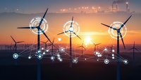 Smart wind turbines with digital network connections generating renewable energy at sunset with industrial backdrop and glowing technological interfaces.