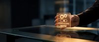 Hand holding glowing cube with configure now text on dark surface, representing business setup, technology configuration, and digital transformation solutions.
