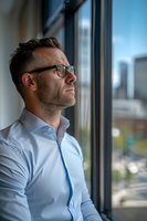 Thoughtful middle-aged Caucasian businessman in glasses and white shirt looking through office window at urban cityscape, contemplating future business decisions.
