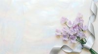 Purple sweet pea flowers with silver ribbon on soft pastel background for wedding invitations, greeting cards and romantic design projects.