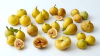 Fresh yellow figs arranged on white background, whole and sliced fruits showing pink interior flesh. Suitable for food photography, culinary content, recipe blogs, and healthy eating materials.