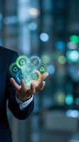 Businessman in dark suit holding glowing holographic sustainability icons including recycling, leaf, and green buildings against blurred urban background for environmental business concepts.