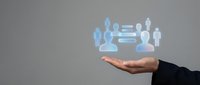 Group of people icons floating above an open palm, representing team management, human resources, and organizational structure for business solutions.