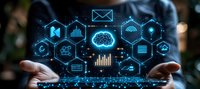 Glowing blue digital icons and cloud computing symbols floating between hands against dark background, representing modern technology and data analytics.