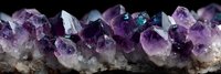 Amethyst crystal cluster with vibrant purple formations and teal inclusions on natural stone base, showcasing raw mineral beauty in geological specimen.