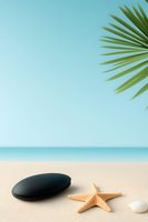 Serene beach scene with black massage stone, starfish and shell on sand under palm frond. Turquoise ocean and clear sky create spa wellness atmosphere.