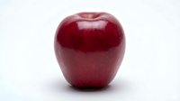Fresh red apple with glossy skin isolated on white background, suitable for healthy eating, nutrition, and food design projects.