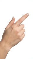 Male hand pointing with index finger isolated on white background for design and presentation use.