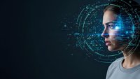 Young woman with futuristic digital interface overlay and glowing blue data visualization circles around her head on dark background.