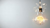 Glowing light bulb with brain inside surrounded by innovation icons and digital network connections on neutral background for creative concepts.