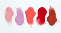Colorful watercolor paint strokes in pink, purple, coral, red and burgundy tones on white background for artistic design projects.