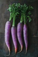 Fresh purple carrots with green tops arranged on dark wooden background, perfect for food photography or farm-to-table content.