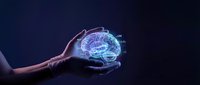 Human hand holding glowing digital brain hologram with neural networks on dark blue background representing artificial intelligence and neuroscience concepts.