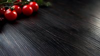 Fresh red cherry tomatoes on dark wooden background with dramatic lighting and copy space for food photography and menu design.