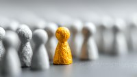 Golden game piece standing out among gray pieces, symbolizing leadership, uniqueness, and differentiation in business strategy or personal development.