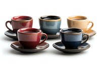 Artisanal ceramic coffee cups and saucers in earthy tones of red, blue, and beige arranged in neat rows on white background, showcasing handcrafted pottery design.