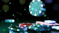 Floating casino chips on dark background with dramatic lighting and bokeh effects, stacks of red, blue and green poker chips for gambling and gaming concepts.