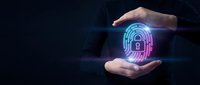 Human hands protecting glowing digital fingerprint with padlock icon representing cybersecurity, data protection and biometric authentication technology.