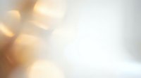 Soft golden bokeh lights creating warm atmospheric glow on white background for elegant design projects and presentations.
