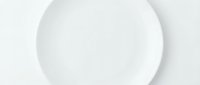 Empty white ceramic plate on white background, isolated and ready for design mockups, product presentations, and tableware advertising.