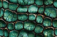 Macro view of emerald green reptilian scales with dark veining and golden highlights creating organic pattern texture for nature and wildlife designs.