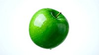 Fresh green apple with water droplets isolated on white background, suitable for food, nutrition, health and wellness design projects.