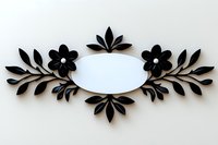 Elegant floral frame with black paper cut flowers and leaves arranged symmetrically around oval white space, creating delicate botanical border design.