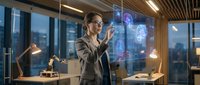 Professional businesswoman interacting with holographic interface technology in modern office environment for futuristic workplace concepts.