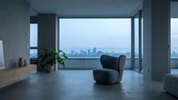 Modern minimalist interior with curved charcoal armchair, potted plant, and expansive city skyline view through floor-to-ceiling windows at dusk.