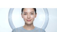 Young Asian woman with clear glowing skin and natural makeup smiling confidently against modern circular background for skincare and beauty concepts.