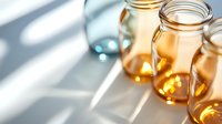 Glowing mason jars with warm honey-colored liquid catching sunlight through window blinds, creating diagonal shadow patterns and ethereal atmosphere.