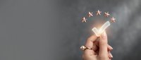 Hand holding glowing pen with five golden stars above representing excellence, quality rating, customer satisfaction and premium service evaluation.