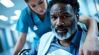 African American senior man receiving physical therapy treatment from female healthcare professional in modern medical facility rehabilitation center.
