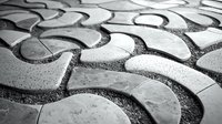 Abstract black and white macro photography of curved stone or ceramic tiles with rough textured grout creating an artistic geometric pattern background.