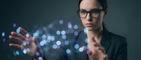 Young Caucasian businesswoman in glasses interacting with glowing digital network, dark background, futuristic technology concept for business and innovation.