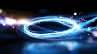 Glowing blue light spiral with sparkles and particles creating dynamic motion effect against dark background, abstract energy flow visualization.
